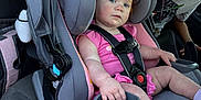 Georgia joined the competition — help win amazing prizes! toddler, child, car_seat, car_interior, seatbelt, pink_clothing, gray_car_seat, red_hair, blue_eyes, socks, person, vehicle, seat, safety_harness, baby, young_child, star_wars_tshirt, window, daylight, family