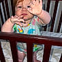 Georgia is registered to the contest to win money with this photo: toddler, crib, baby, child, indoor, wooden_furniture, plush_toy, colorful_clothing, reaching_hands, curious, bedroom, blanket, person, infant, cute, standing, playful, young_child, expression, pajamas