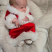 Rachel is registered to the contest to win money with this photo: baby, infant, santa_outfit, red_clothing, white_fur, blanket, soft_texture, cozy, cute, holiday, christmas, warm, newborn, portrait, child, socks, indoor, resting, small_hands, fur_trim