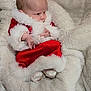 baby, infant, santa_outfit, red_clothing, white_fur, blanket, soft_texture, cozy, cute, holiday, christmas, warm, newborn, portrait, child, socks, indoor, resting, small_hands, fur_trim