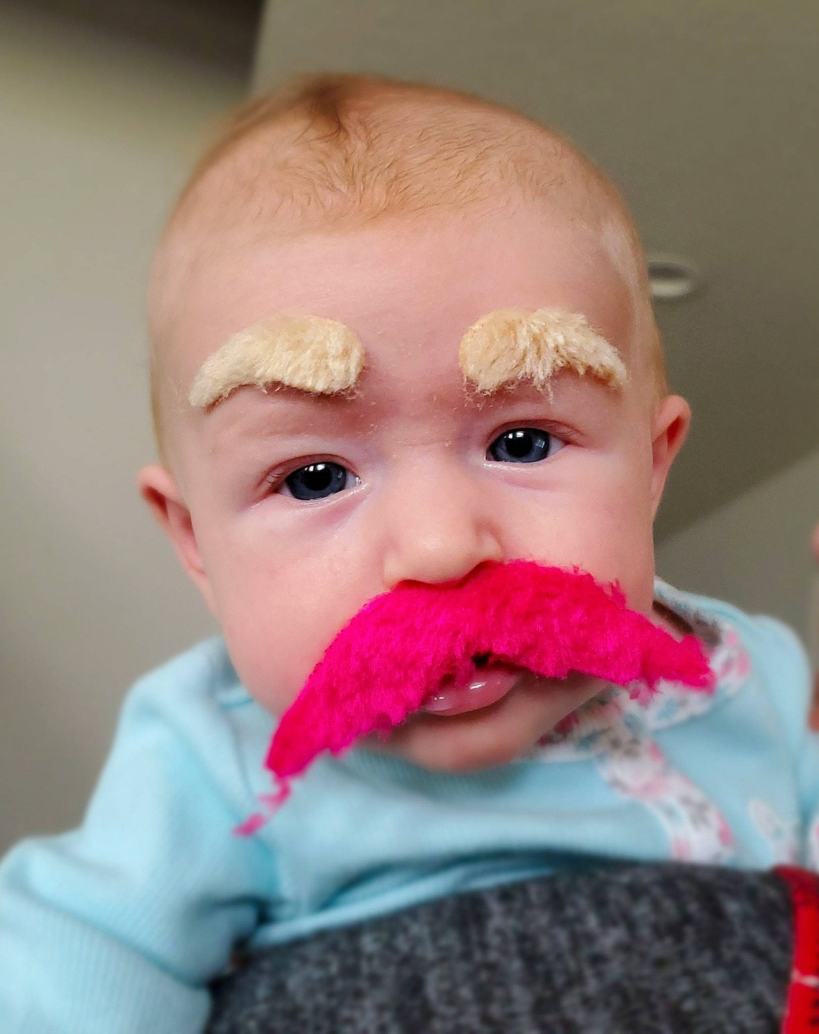 Lilith is registered to the contest to win money with this photo: baby, beard, cheek, child, chin, close_up, eating, face, facial_hair, hair, head, lip, moustache, mouth, nose, person, pink, skin, toddler