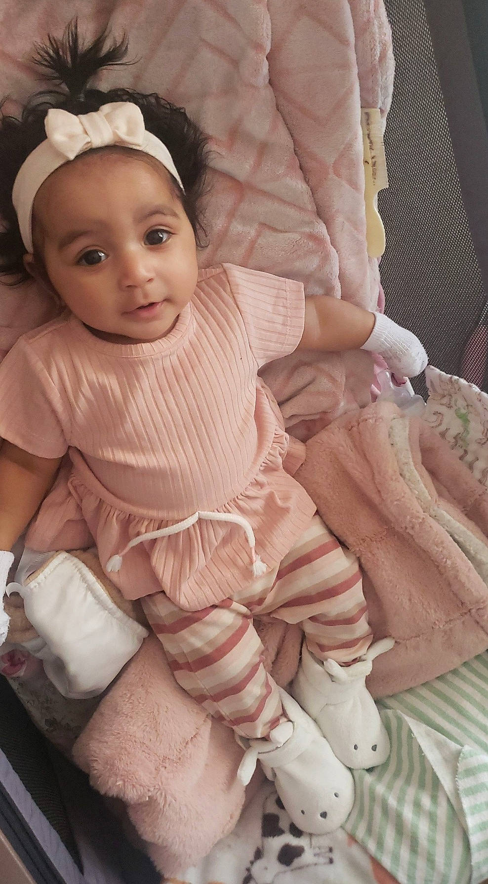 Danna is registered to the contest to win money with this photo: arm, baby, baby_toddler_clothing, cheek, child, comfort, eye, face, fashion_accessory, finger, flash_photography, hand, headgear, peach, person, pink, sitting, skin, sleeve, thumb