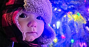 Wyatt joined the competition — help win amazing prizes! toddler, child, winter_clothing, hat, ear_flaps, red_and_black_checkered, face, curious, snow, holiday_lights, colorful_lights, night, outdoor, winter, cold_weather, portrait, close_up, young_child, cute, warm_clothing