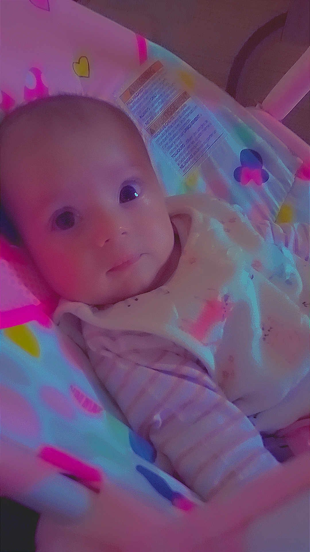 Mya participe au concours pour gagner de l'argent avec cette photo : baby, infant, face, child, cute, seat, patterned, clothing, striped, lying_down, indoor, colorful, soft_lighting, portrait, expression, young, person, closeup, baby_bouncer, resting