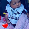 Nykajiah is registered to the contest to win money with this photo: baby, infant, blanket, headband, bow, bib, eagle_logo, clothing, cute, pink, soft, pacifier_clip, person, portrait, indoor, child, love_emoji, expression, seated, adorable