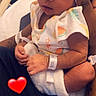 baby, newborn, infant, sleeping, pink_bow, hospital, hospital_wristband, arm, hand, tattoo, blanket, cute, closeup, person, love, heart_emoji, resting, soft_lighting, cozy, parent