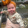 Darla-Marie is registered to the contest to win money with this photo: baby, child, shopping_cart, headband, bow, tongue_out, blanket, grocery_store, clothing, cute, smiling, person, infant, shopping, seat, hand, floor, sleeves, patterned_clothing, indoor