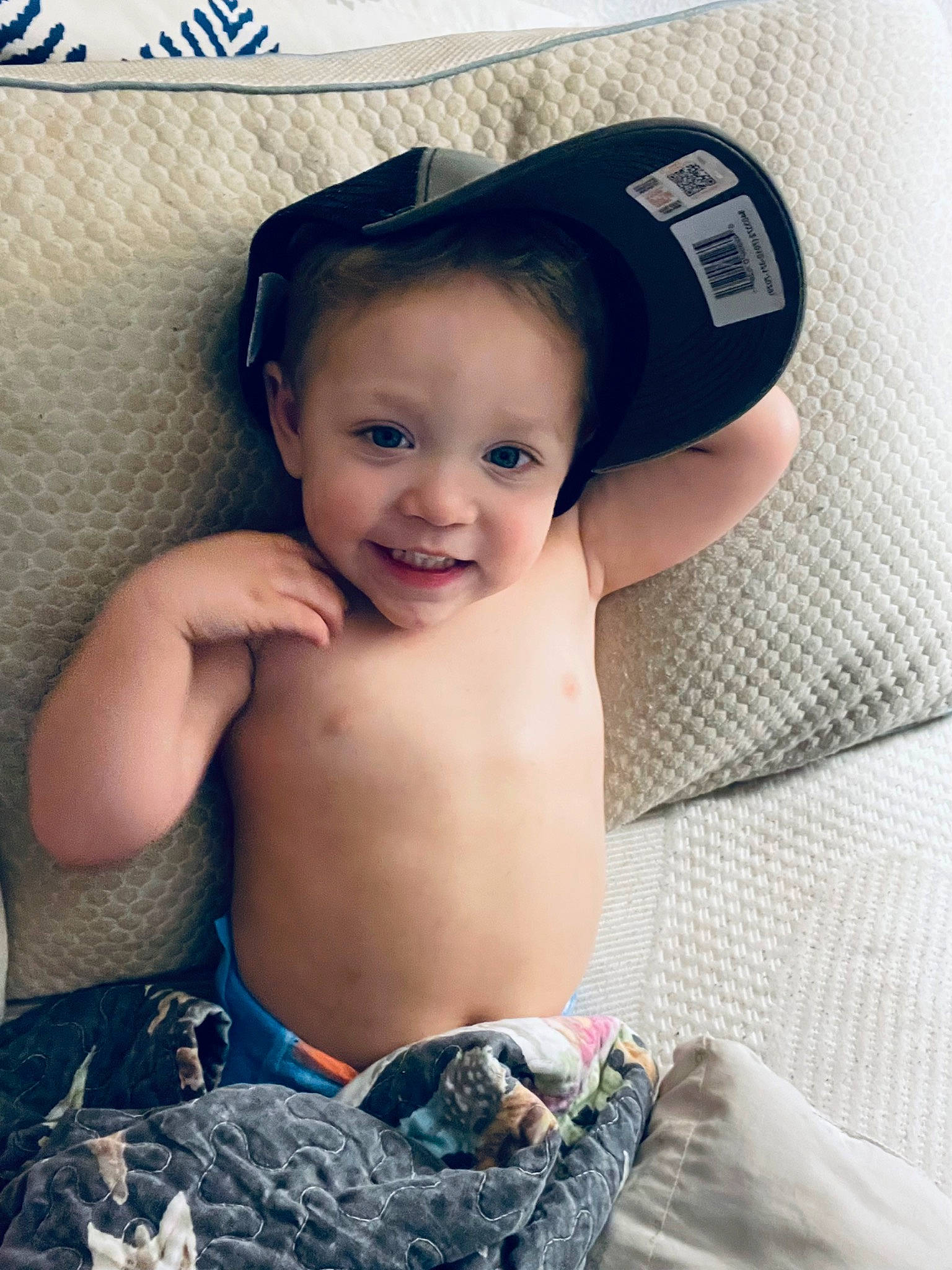 Dennis is registered to the contest to win money with this photo: baby, baby_toddler_clothing, baseball_cap, blue, cap, chest, child, comfort, cool, face, finger, flash_photography, happy, hat, joy, muscle, pattern, person, skin, smile