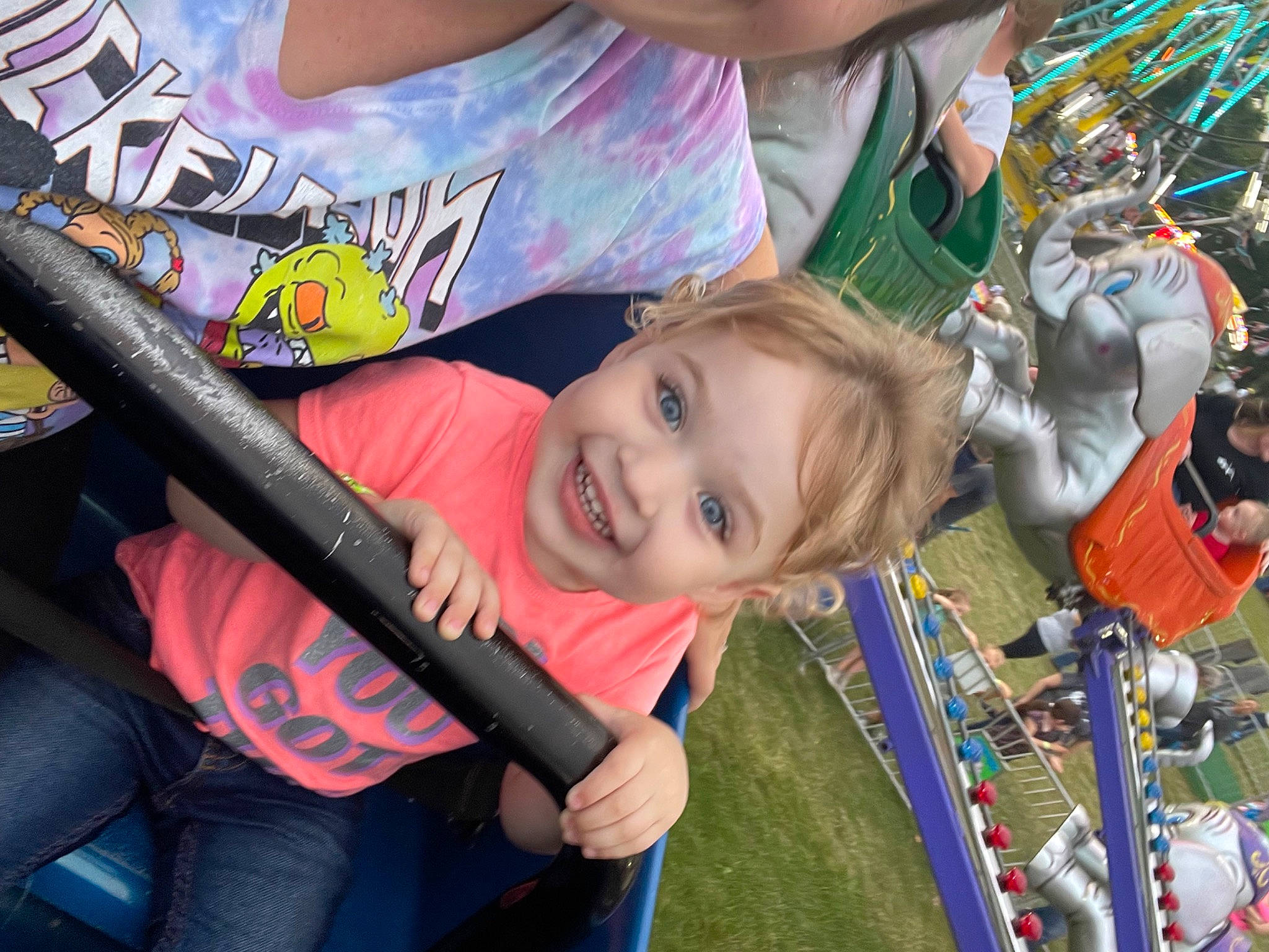 Leanna joined the competition — help win amazing prizes! blurred, child, clothing, facial_expression, fun, grass, green, happy, human_body, joy, leisure, people, person, photograph, product, recreation, smile, snapshot, summer, t_shirt