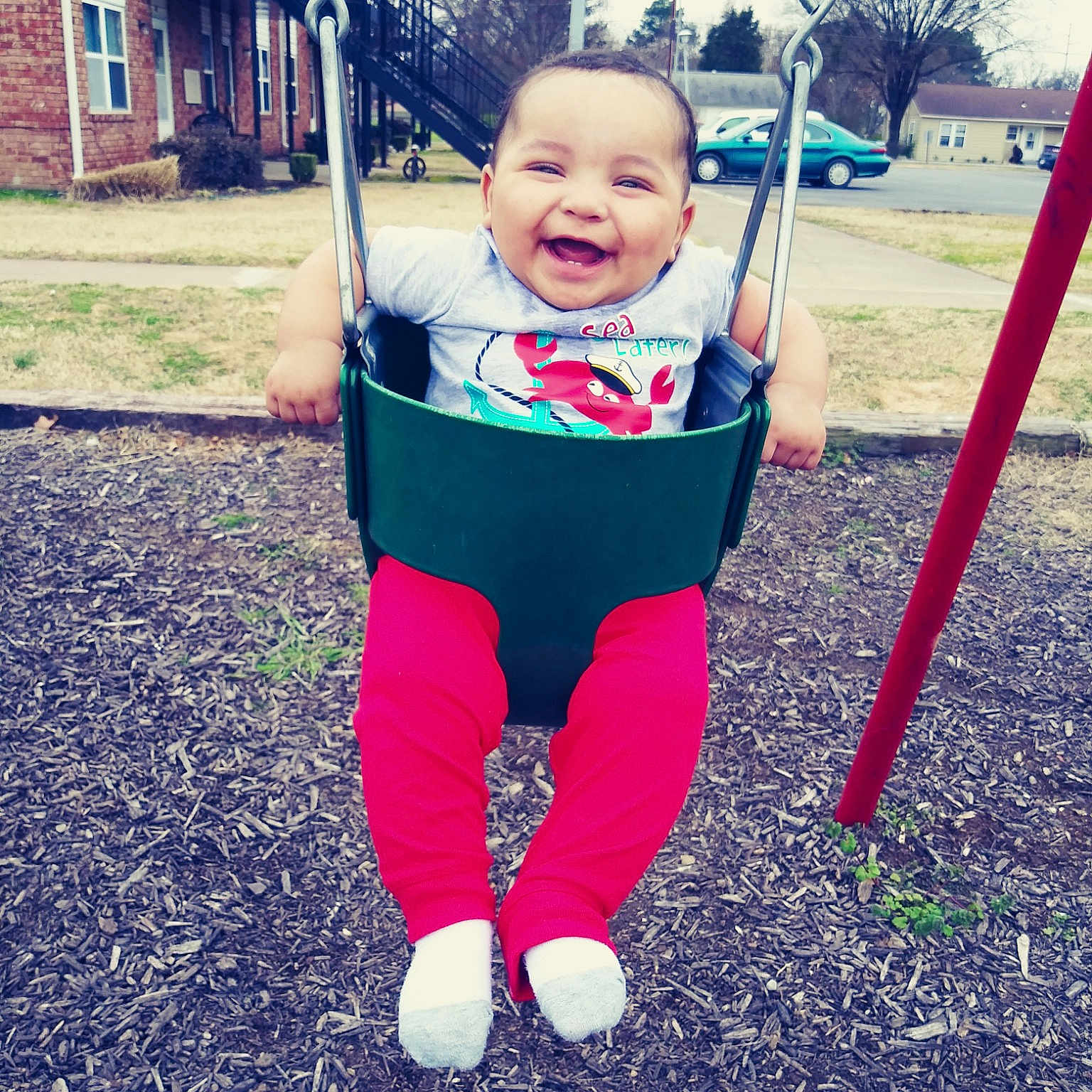 Tavaris joined the competition — help win amazing prizes! baby, child, city, facial_expression, fun, happy, human_settlement, joy, outdoor_play_equipment, person, play, playground, public_space, recreation, sky, smile, swing, toddler, tree