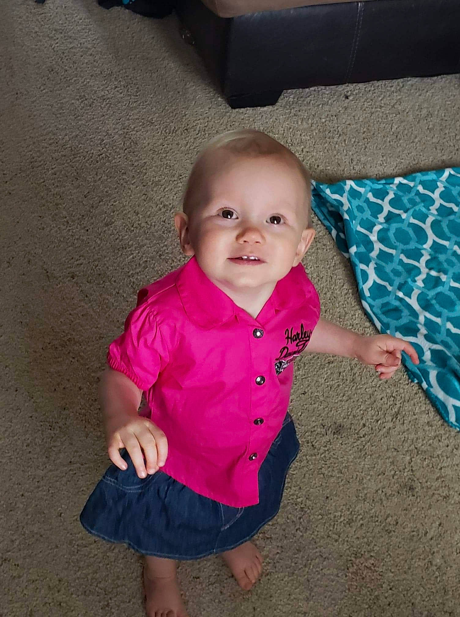 Azlynn is registered to the contest to win money with this photo: baby, cheek, child, eye, face, fun, head, iris, leg, magenta, person, pink, play, sitting, skin, smile, standing, toddler