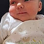 Phoebe is registered to the contest to win money with this photo: baby, infant, face, onesie, clothing, newborn, portrait, cute, child, young, skin, head, expression, person, sleepwear, soft, indoors, resting, closeup, newborn_clothing