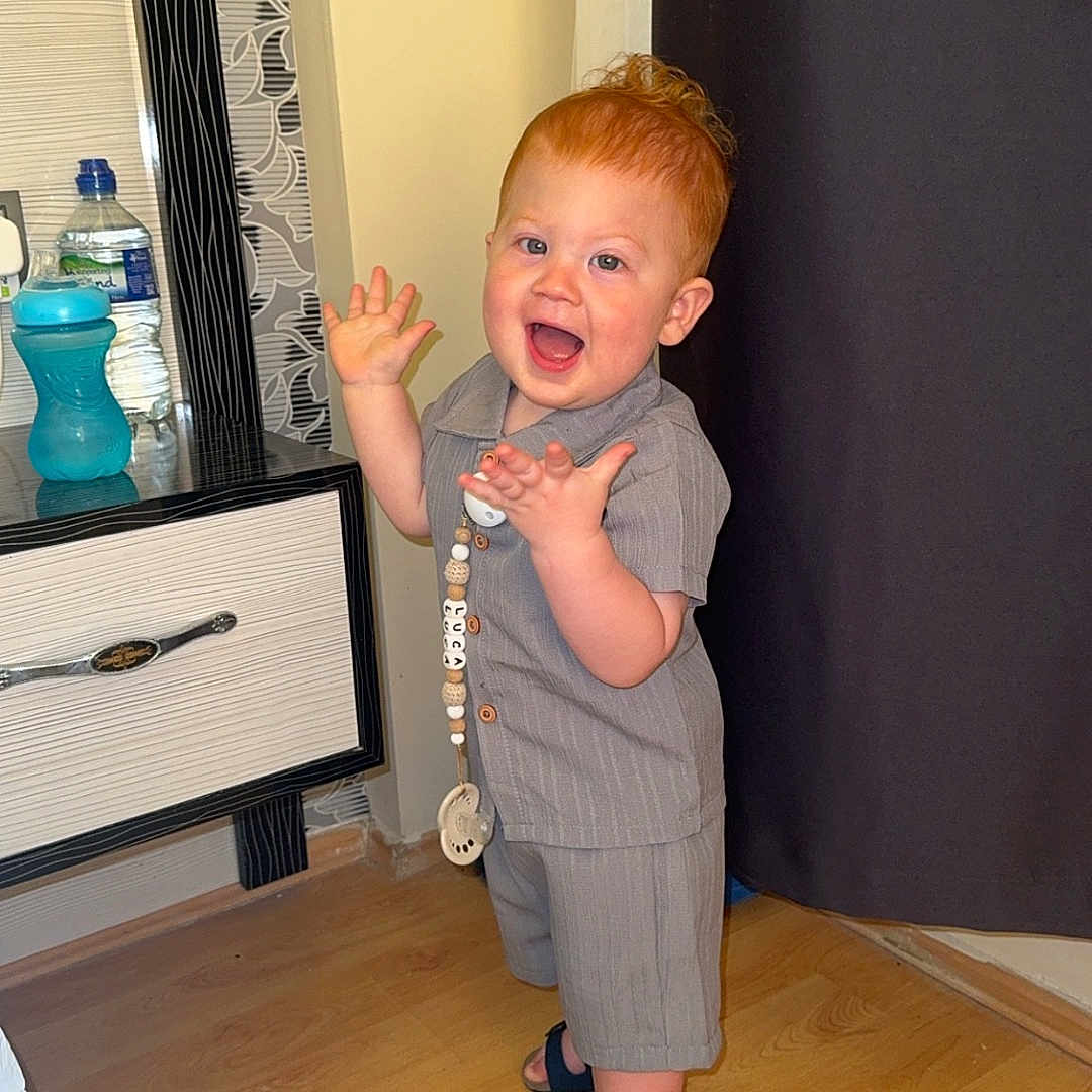 Luca joined the competition — help win amazing prizes! baby, cabinet, clothing, dress, face, footwear, formalwear, furniture, hardwood, head, indoors, interiordesign, pants, person, photography, plywood, portrait, sandal, shoe, wood