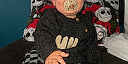 Hunter-James joined the competition — help win amazing prizes! baby, pacifier, child, bed, sweater, checkered_pants, sock, headboard, photo_wall, blue_wall, hand, infant, indoor, portrait, cozy, curious, reaching, clothing, young_child, cute
