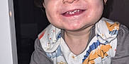 Hunter-James is registered to the contest to win money with this photo: baby_teeth, child, close_up, clothing, cute, dinosaur_print, face, flash, happy, indoor, infant, joy, long_sleeves, messy_face, person, playful, portrait, smiling, toddler, young_child