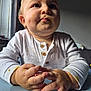 Hunter-James is registered to the contest to win money with this photo: baby, child, chubby_cheeks, closeup, cozy, curious_expression, cute, face, food, hands, indoor, infant, long_sleeves, messy, natural_light, portrait, soft_light, table, white_clothing, window