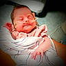 Maggie joined the competition — help win amazing prizes! newborn, baby, infant, sleeping, smiling, face, portrait, swaddled, blanket, hospital, medical_tape, pink_clothing, hands, fingers, indoors, close_up, infant_care, peaceful, bedding, photography