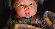 Declan joined the competition — help win amazing prizes! baby, infant, child, car_seat, beanie, blanket, pacifier, portrait, face, eyes, wide_eyed, looking_at_camera, seated, bundled, warm_clothing, car_interior, safety_harness, cozy, close_up, photograph