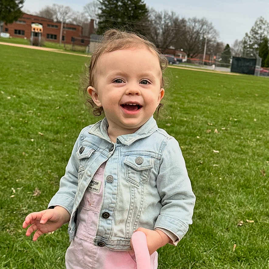 Graceyln joined the competition — help win amazing prizes! basket, casual_clothing, child, cloudy_sky, cute, daytime, denim_jacket, field, flower, grass, happy, outdoor, pants, person, pink, playful, shoes, smiling, toddler, tree