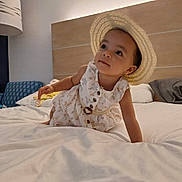 Elcie is registered to the contest to win money with this photo: baby, bed, bedroom, bonnet, clothing, crawling, cushion, face, furniture, hat, head, homedecor, indoors, interiordesign, person, photography, portrait, room, sitting, sunhat