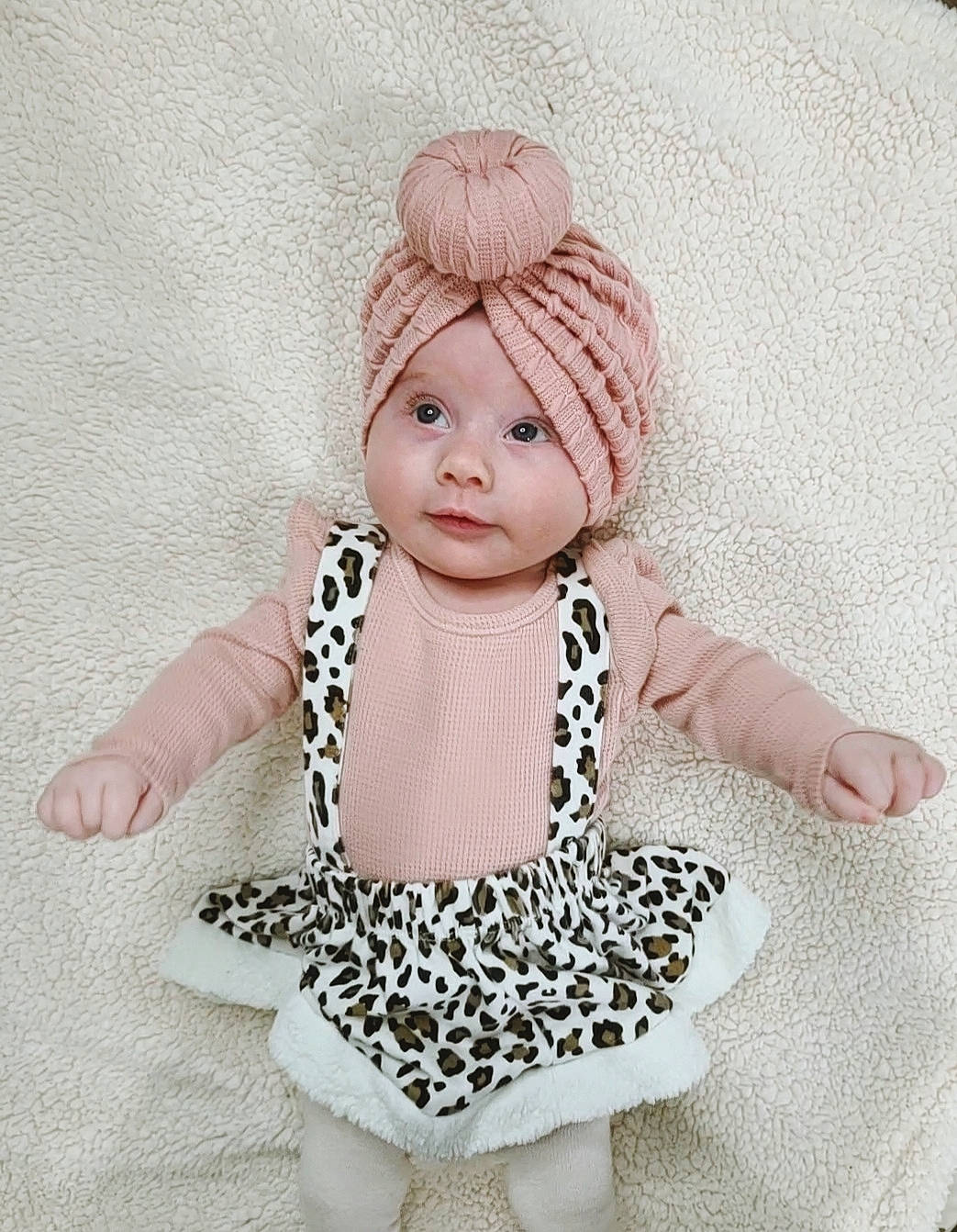 Sutton is registered to the contest to win money with this photo: baby_toddler_clothing, cap, costume_hat, doll, eyelash, fashion_design, font, head, headgear, headpiece, headwear, jewellery, knit_cap, neck, necklace, outerwear, pattern, person, pink, sleeve