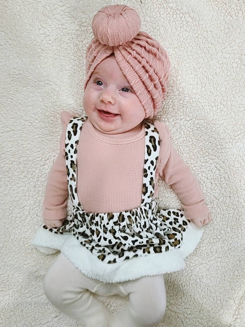 Sutton is registered to the contest to win money with this photo: baby, baby_toddler_clothing, cap, collar, dress, fashion_accessory, hair_accessory, happy, headgear, headwear, joy, magenta, neck, outerwear, pattern, person, pink, sleeve, smile, street_fashion