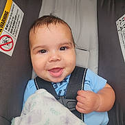 Dean joined the competition — help win amazing prizes! baby, car_seat, smile, child, infant, blanket, blue_clothing, seatbelt, happy, face, cute, young_child, safety, indoors, head, person, portrait, skin, hand, comfort