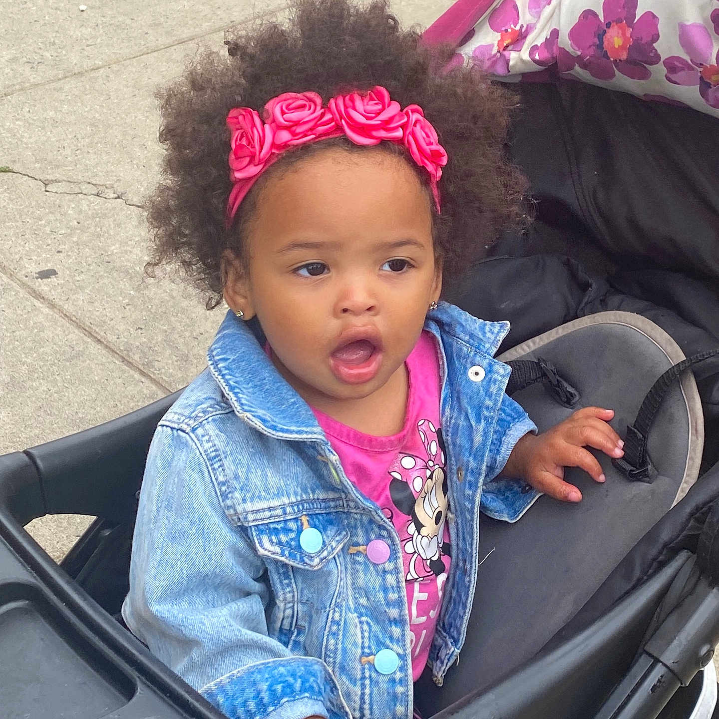 Legacy joined the competition — help win amazing prizes! afro, baby, black_hair, casual_clothing, child, curious, cute, daylight, denim_jacket, flower, headband, minnie_mouse, open_mouth, outdoor, person, pink, portrait, sidewalk, stroller, toddler