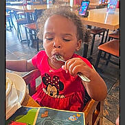 Legacy joined the competition — help win amazing prizes! child, toddler, girl, eating, fork, red_dress, minnie_mouse, restaurant, table, chair, high_chair, placemat, plate, activity_sheet, messy, curly_hair, earrings, indoor, concentration, family_dining
