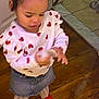 toddler, child, indoor, floor, wooden_floor, tile_floor, heart_pattern, sweater, denim_skirt, red_shoes, curious, standing, person, clothing, cute, young_child, hands, looking_down, hair_tied, casual