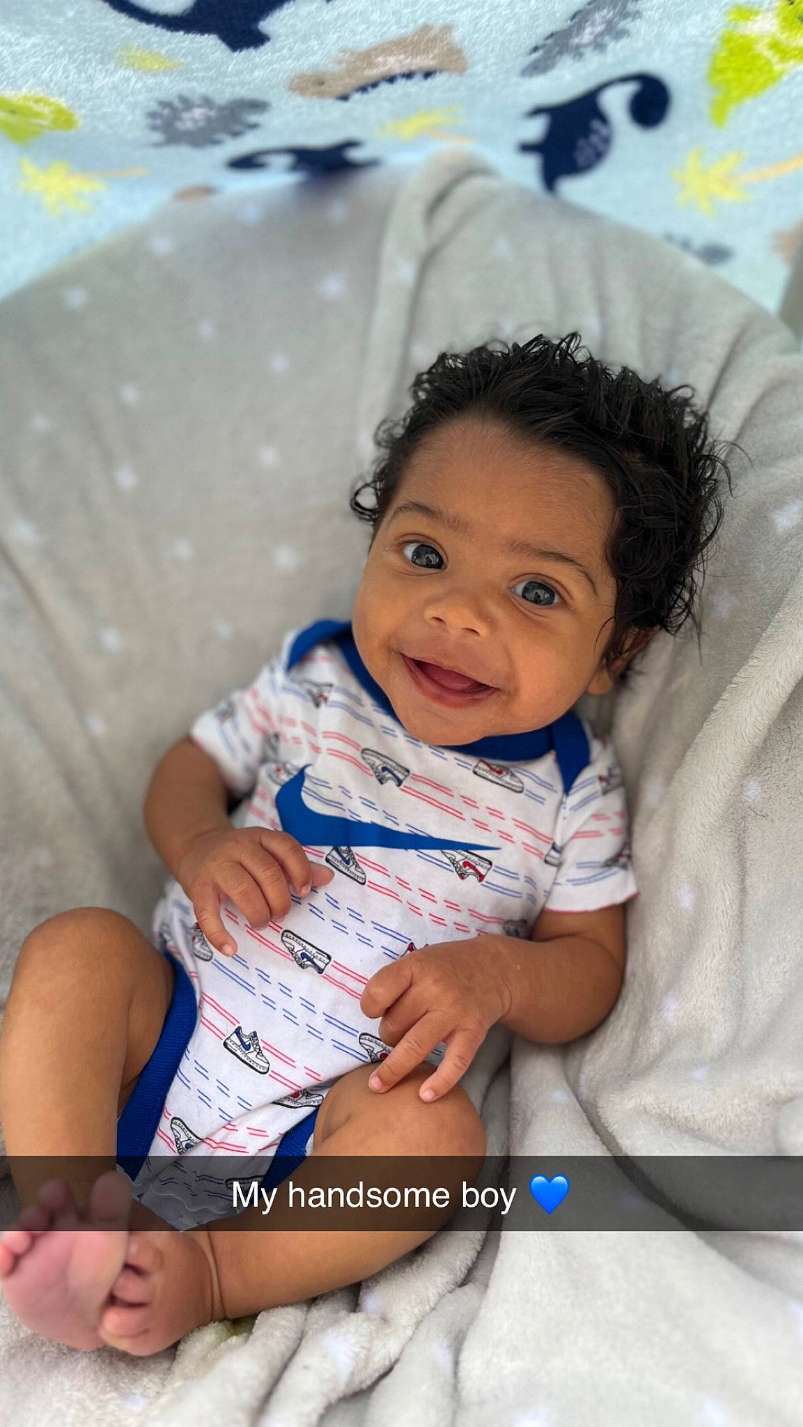 Tahj is registered to the contest to win money with this photo: abdomen, baby, cheek, child, comfort, event, eye, finger, flash_photography, fun, happy, leisure, linens, people, person, room, sitting, skin, smile, thigh