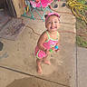 toddler, child, smiling, pink_outfit, headband, popsicle, barefoot, porch, concrete, chair, hose, outdoor, summer, happy, playful, young_child, person, casual, daylight, backyard