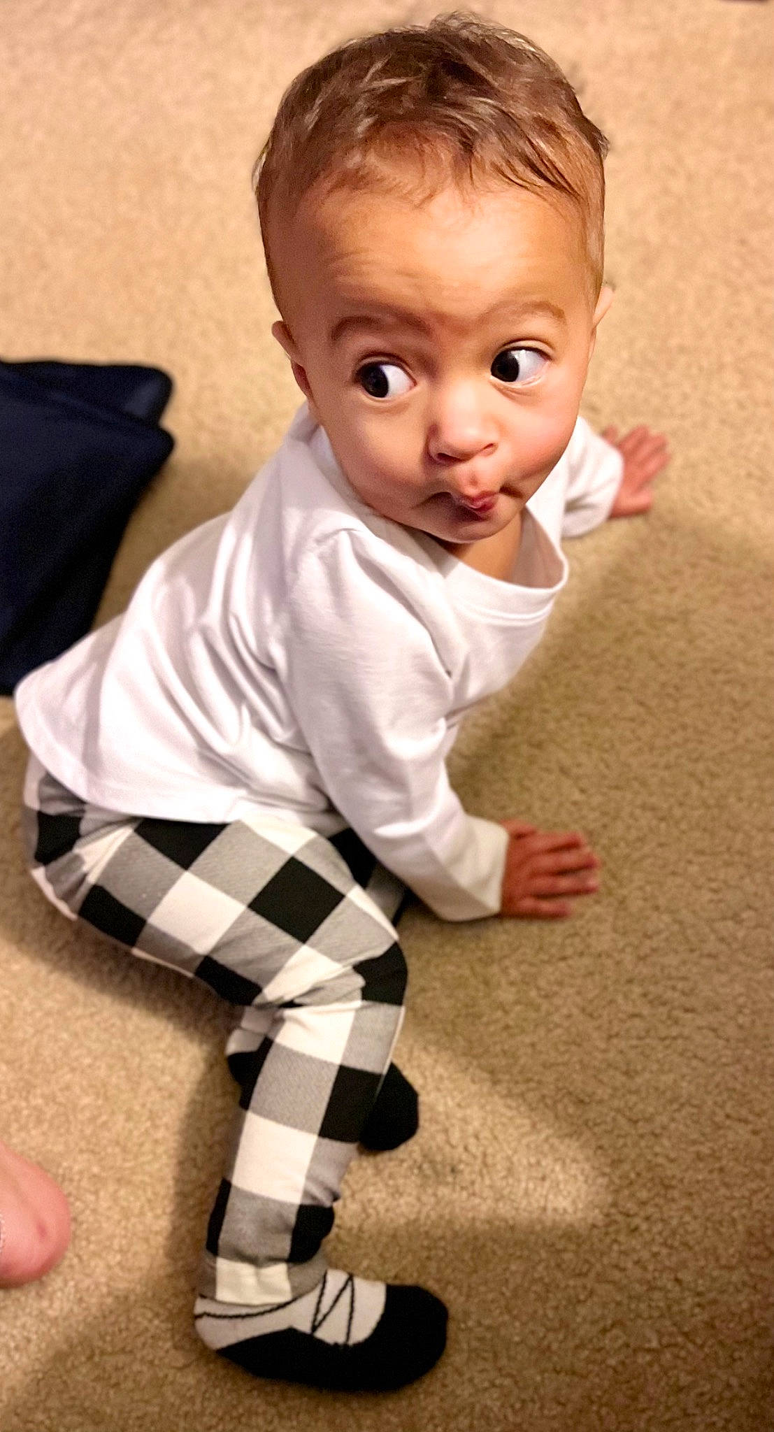 Kynsley joined the competition — help win amazing prizes! baby, baby_toddler_clothing, cheek, child, finger, floor, flooring, human_body, human_leg, knee, leg, pattern, person, plaid, sitting, sleeve, sock, tartan, thigh, thumb