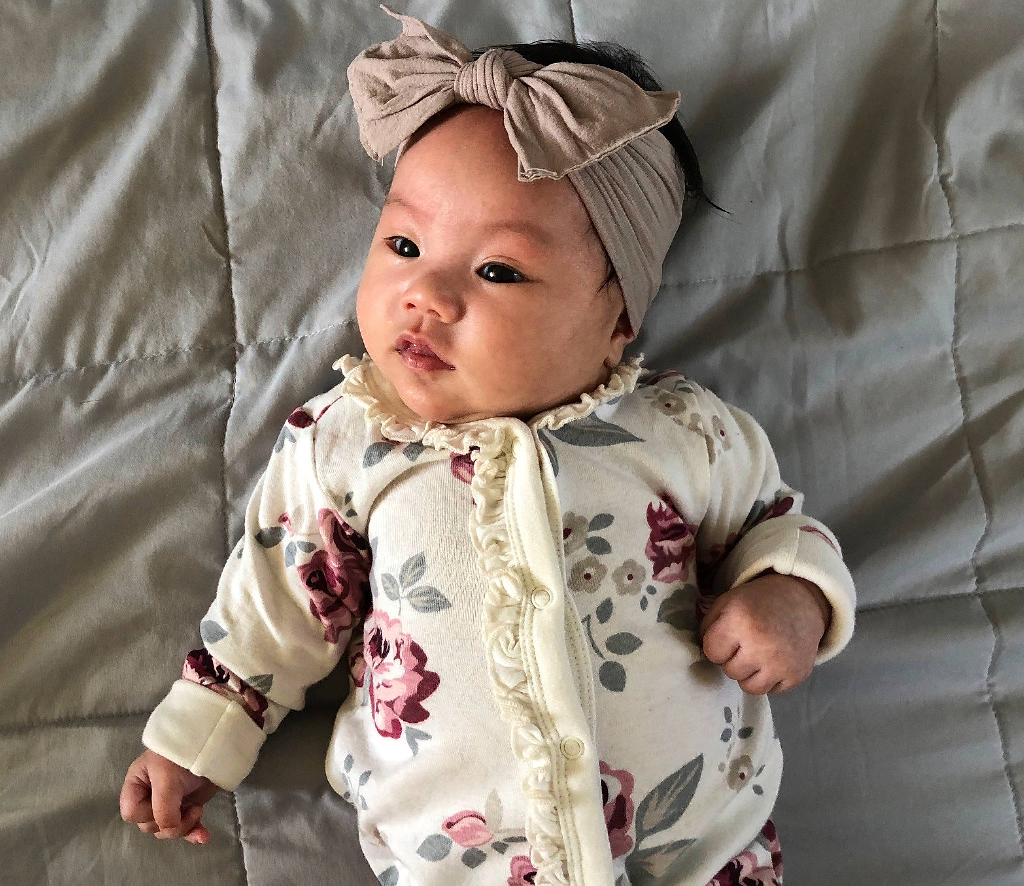 Ezri is registered to the contest to win money with this photo: baby, baby_products, baby_toddler_clothing, beige, cheek, child, hair_accessory, headgear, headwear, outerwear, pattern, person, product, sleeve, toddler