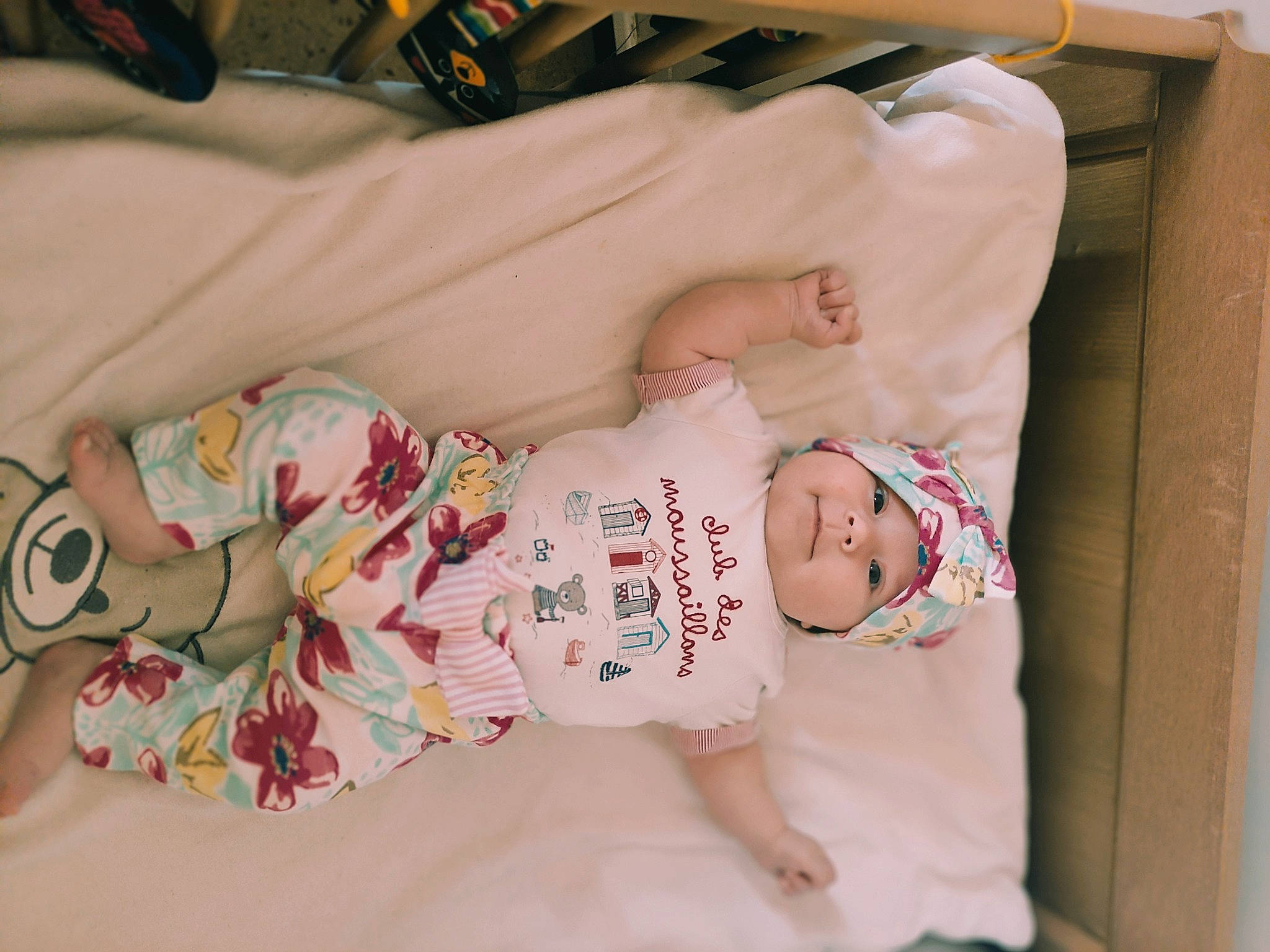 Karina participe au concours pour gagner de l'argent avec cette photo : baby, baby_products, baby_safety, baby_sleeping, baby_toddler_clothing, bed, bedding, cheek, child, comfort, dress, face, headwear, linens, person, pink, product, room, skin, sleeve