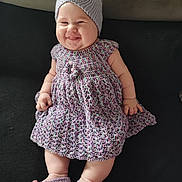 Eliza Amaryllis participe au concours pour gagner de l'argent avec cette photo : baby, smiling, knitted_hat, knitted_dress, knitted_booties, infant, happy, cute, sitting, indoors, couch, soft_fabric, plush, child, portrait, cute_expression, chubby_cheeks, handmade_clothing, cozy, comfortable
