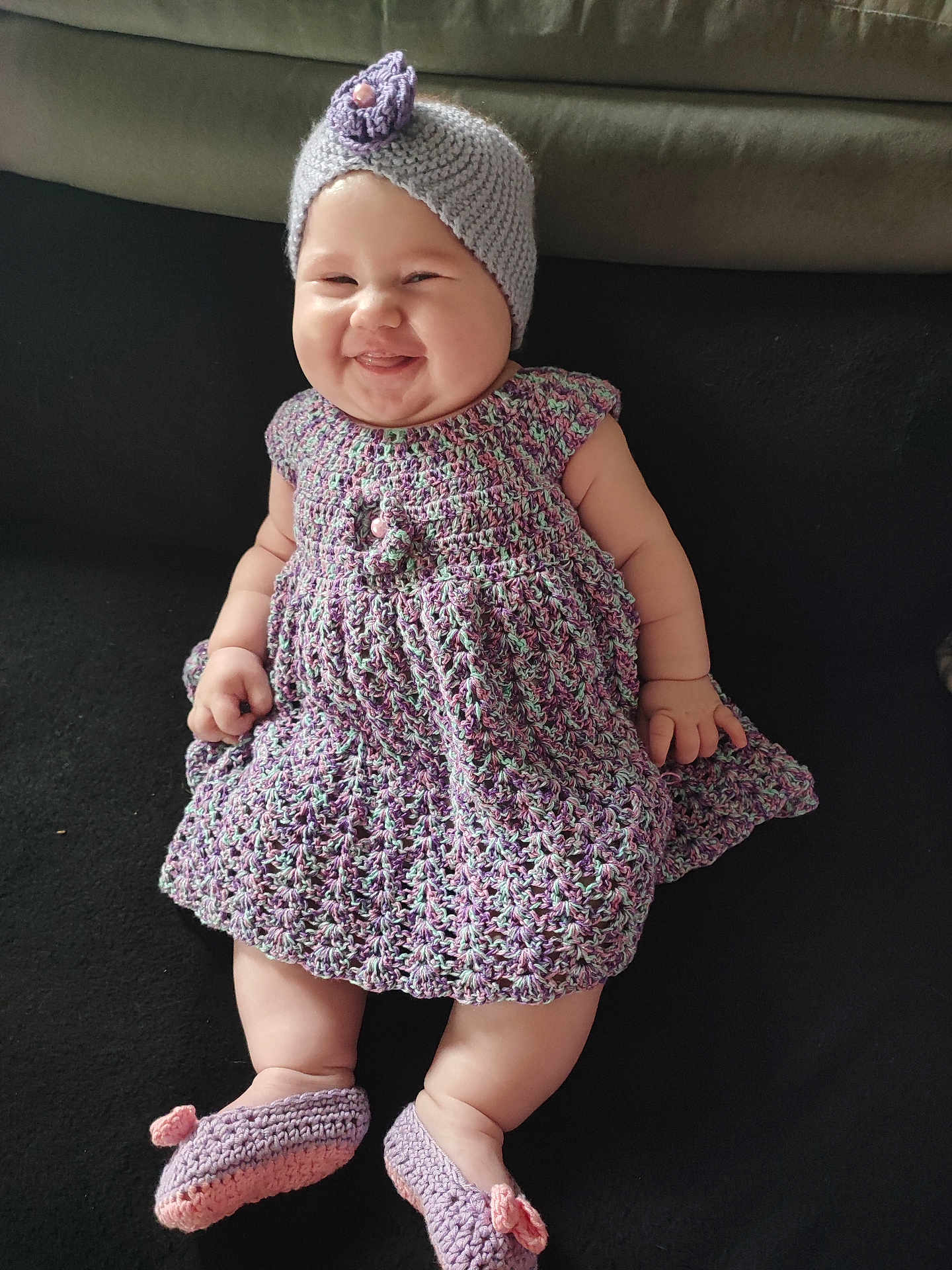 Eliza Amaryllis participe au concours pour gagner de l'argent avec cette photo : baby, smiling, knitted_hat, knitted_dress, knitted_booties, infant, happy, cute, sitting, indoors, couch, soft_fabric, plush, child, portrait, cute_expression, chubby_cheeks, handmade_clothing, cozy, comfortable