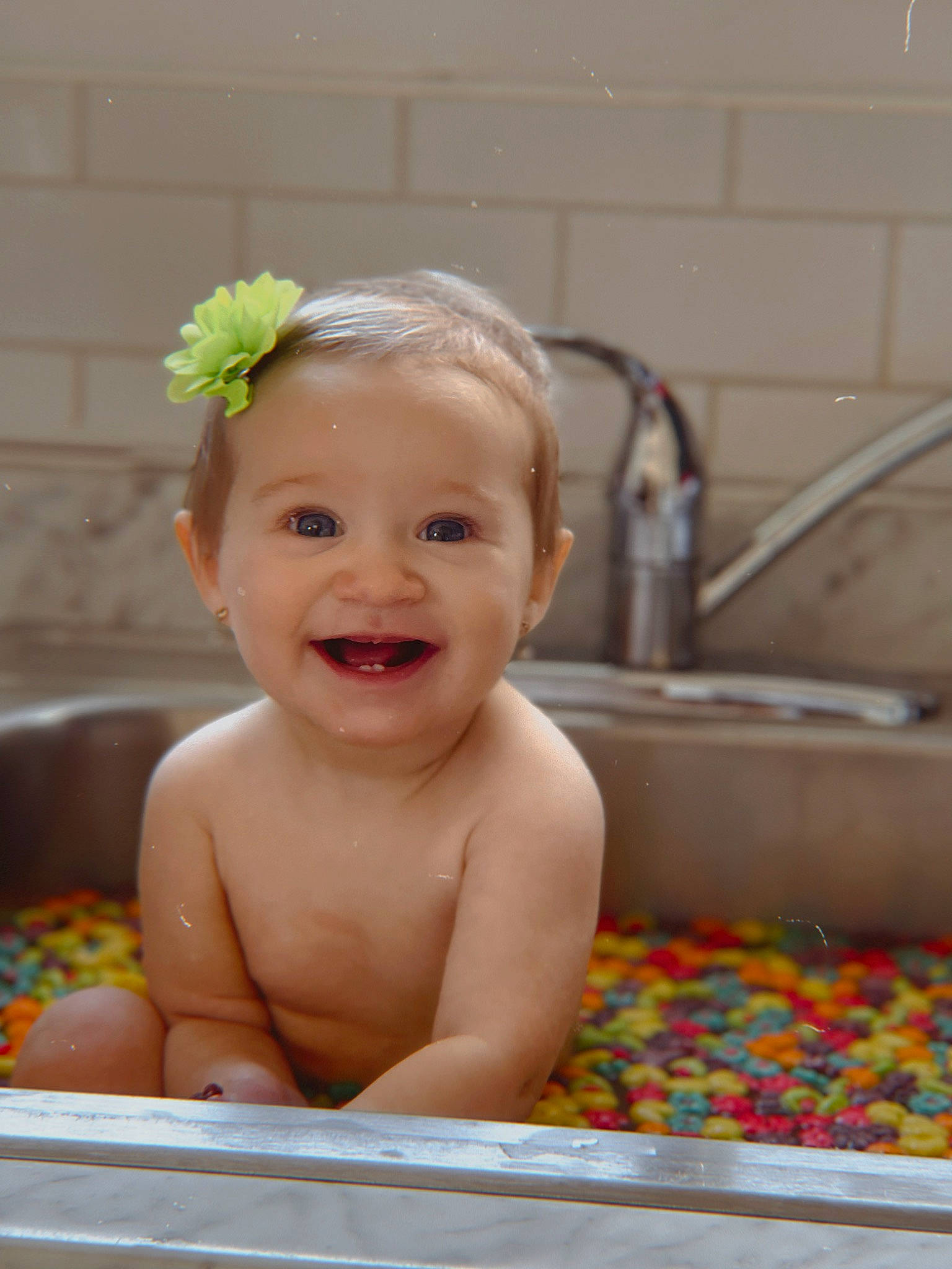 Giavanna is registered to the contest to win money with this photo: baby, baby_bathing, baby_playing_with_toys, bathing, cheek, ear, eye, fluid, green, hair, happy, head, joy, organ, person, photograph, product, sink, skin, smile