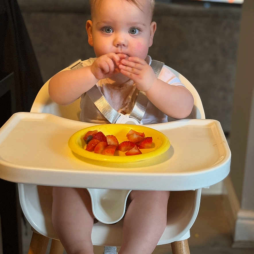 Jacob is registered to the contest to win money with this photo: baby, bodypart, chair, cutlery, diningtable, dish, eating, face, finger, food, furniture, hand, head, indoors, ketchup, lunch, meal, person, plate, table