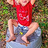 toddler, child, blond_hair, blue_eyes, red_shirt, shorts, barefoot, metal_tub, outdoor, leaves, grass, nature, playful, smiling, sitting, cute, portrait, daylight, casual, happy