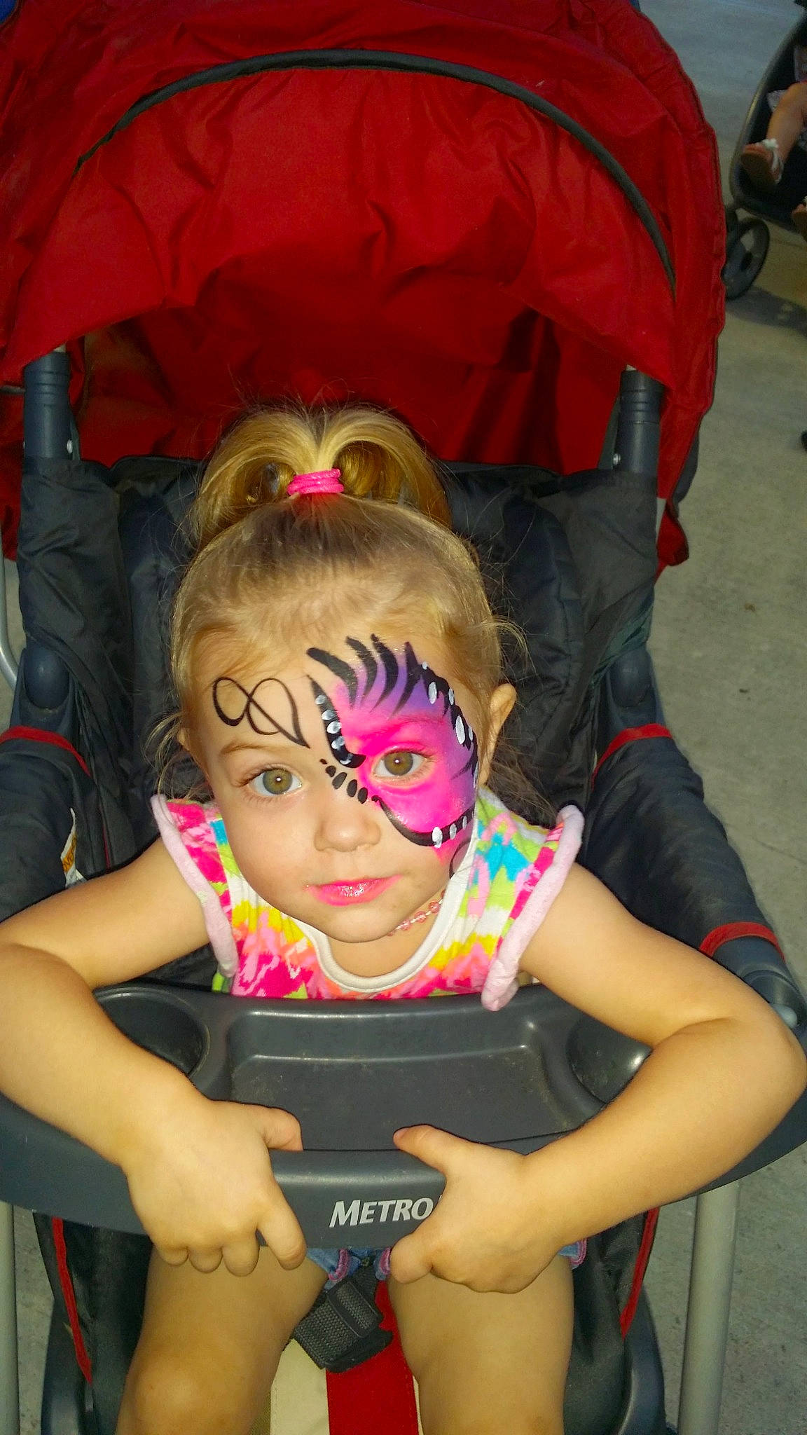 Averie is registered to the contest to win money with this photo: child, cool, event, eyewear, facial_expression, fun, happy, leisure, magenta, mouth, person, photograph, pink, sitting, snapshot, t_shirt, thigh, tire, toddler, vacation