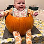 baby, pumpkin, table, smiling, pajamas, bib, indoor, child, face, happy, tablecloth, orange, holiday, cute, costume, autumn, festive, celebration, sitting, infant