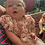 Storibelle is registered to the contest to win money with this photo: baby, infant, child, pink_dress, bow, fabric_roses, close_up, person, holding, indoor, face, head, open_mouth, skin, hand, clothing, sitting, background, blur, casual