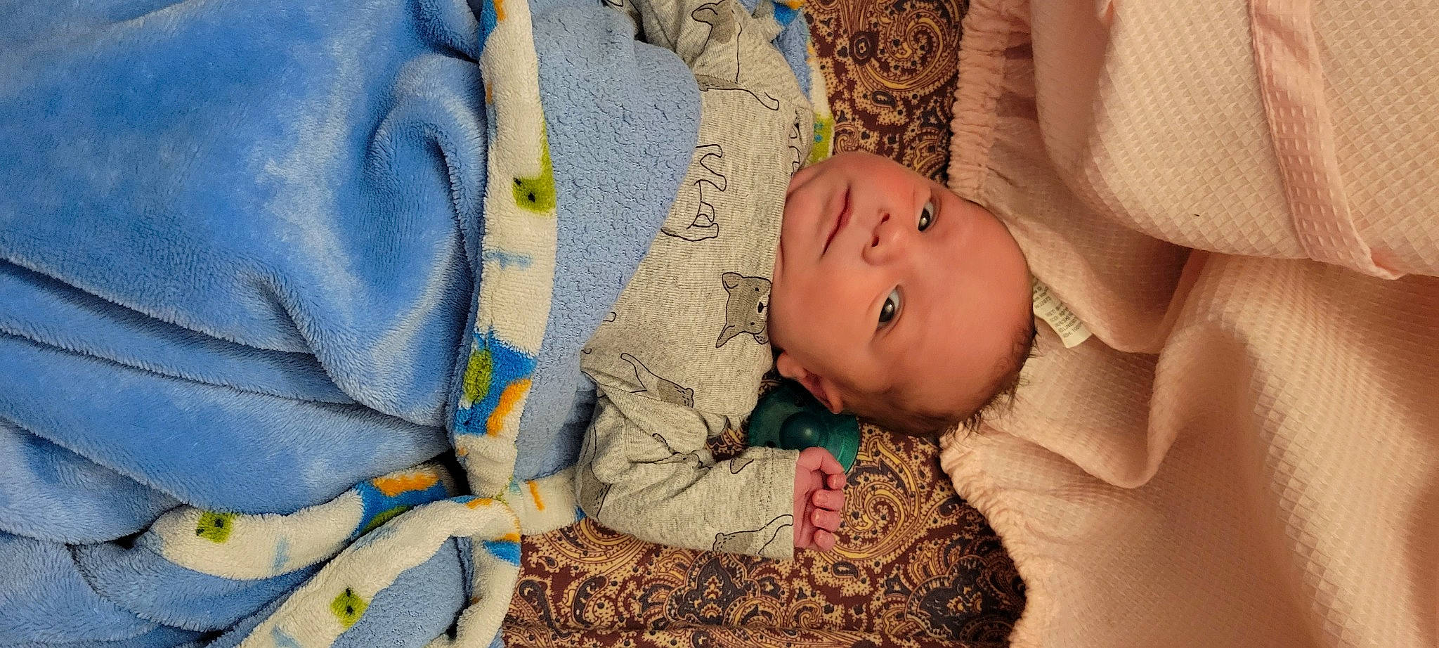 Hagen is registered to the contest to win money with this photo: arm, azure, baby, cheek, comfort, eye, face, finger, flooring, hand, happy, head, human_body, iris, linens, person, product, skin, textile, toddler