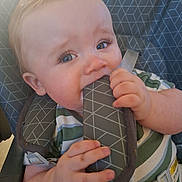 Jace is registered to the contest to win money with this photo: baby, blue_eyes, car_seat, chewing, child, closeup, curious, cute, face, hand, harness, indoor, infant, mischievous, padded_strap, seatbelt, sitting, soft_lighting, striped_shirt, young_child