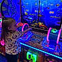child, arcade, game, neon_lights, fishing_game, gaming_machine, indoor, colorful, entertainment, young_girl, playing, technology, fun, leisure, electronics, screen, buttons, casual, amusement, bright