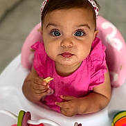 Leya a rejoint le concours — aidez-le/la à gagner de superbes lots ! baby, child, pink_clothing, headband, blue_eyes, highchair, toy, butterfly_toy, colorful_ball, snack, indoor, closeup, portrait, cute, infant, sitting, food, hand, face, curious