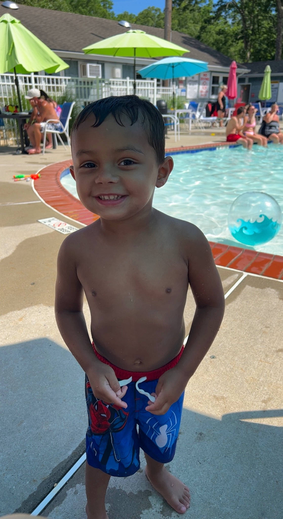 Malakai is registered to the contest to win money with this photo: abdomen, barechested, chest, child, fun, happy, joint, joy, leisure, muscle, person, photograph, recreation, smile, summer, swimming_pool, toddler, trunk, trunks, umbrella