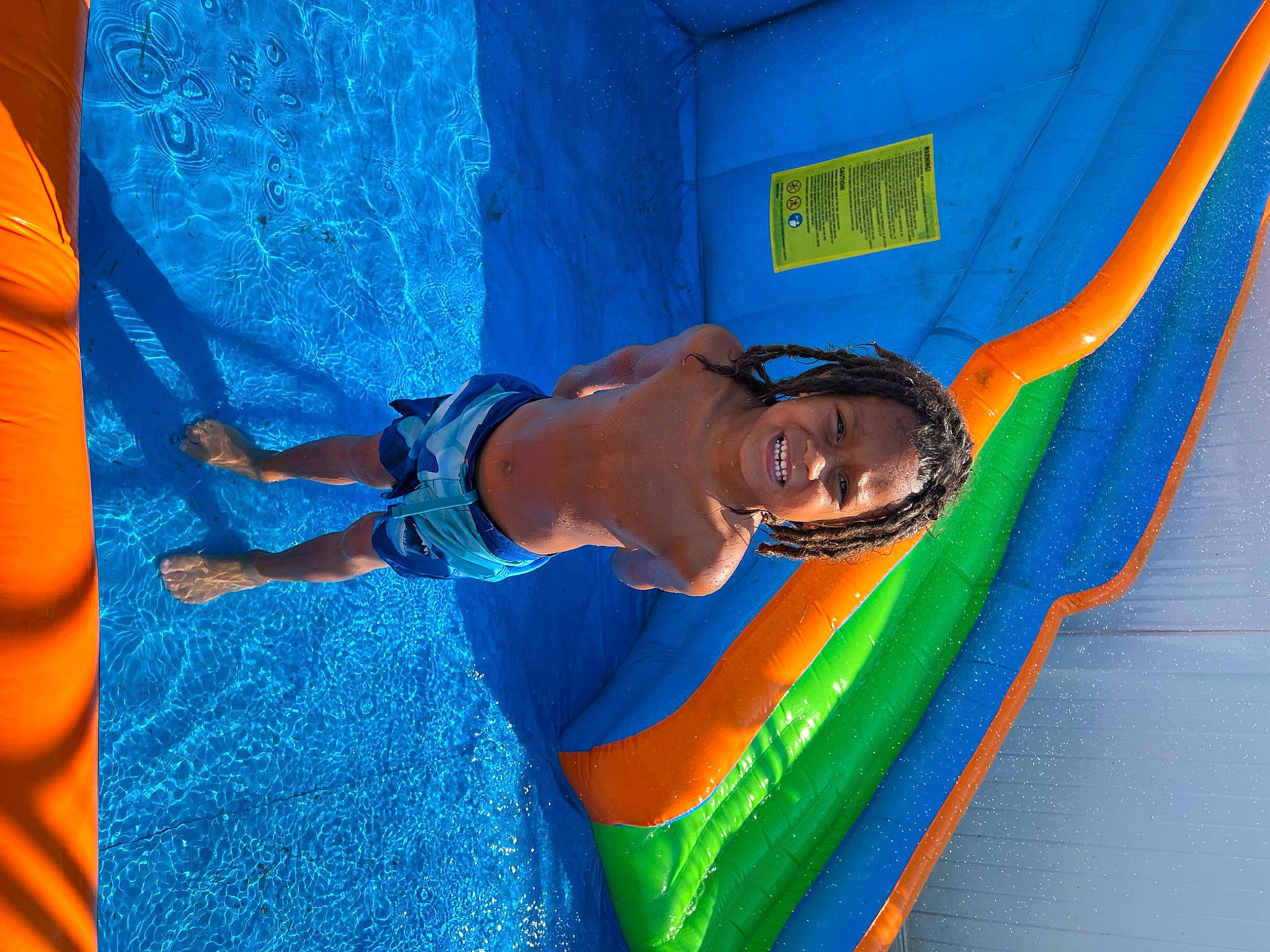 Leo is registered to the contest to win money with this photo: aqua, azure, blue, child, chute, electric_blue, fun, happy, inflatable, joy, leisure, paint, people_in_nature, person, play, recreation, smile, t_shirt, textile, toddler
