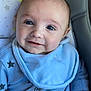 Cody is registered to the contest to win money with this photo: baby, blue_onesie, bib, smile, face, infant, star_pattern, hand, blue_eyes, seated, soft_background, cute, child, portrait, clothing, indoor, closeup, person, young_child, adorable